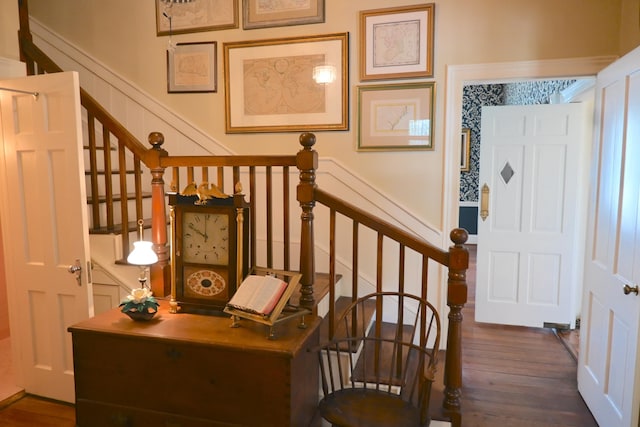 stairway featuring wood finished floors