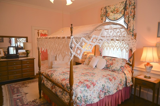 bedroom with a wainscoted wall and ornamental molding