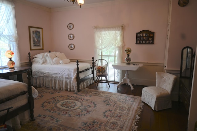 bedroom featuring crown molding and wood finished floors