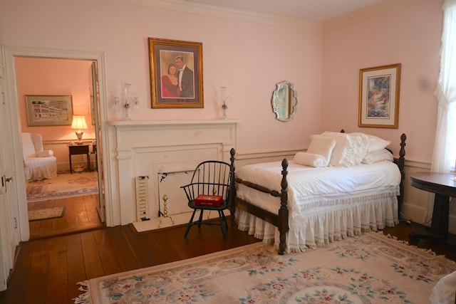 bedroom featuring crown molding and wood-type flooring