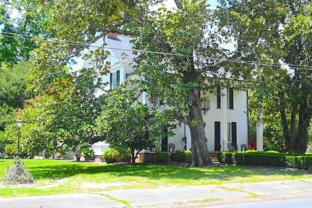 obstructed view of property featuring a front yard