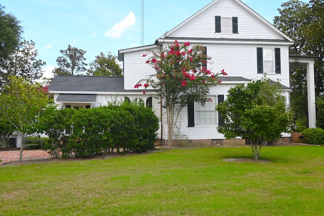 exterior space featuring a yard, roof with shingles, and crawl space