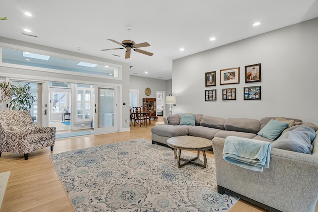 living area with visible vents, recessed lighting, light wood-type flooring, and ceiling fan