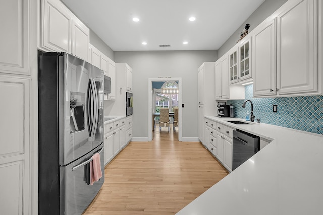 kitchen with white cabinets, stainless steel appliances, and a sink