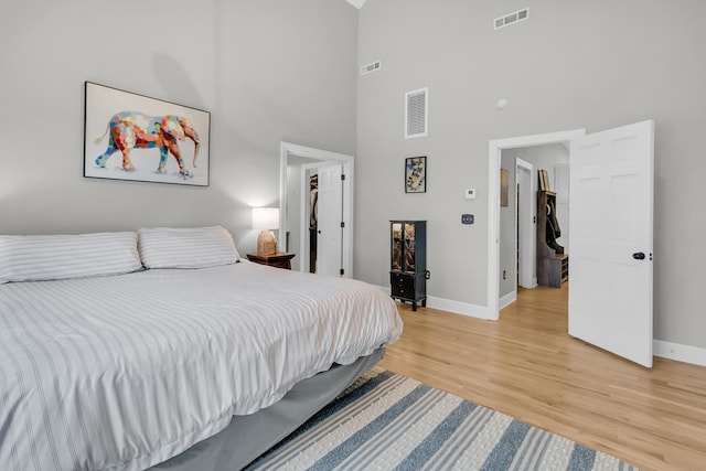 bedroom featuring visible vents, baseboards, and light wood-style floors