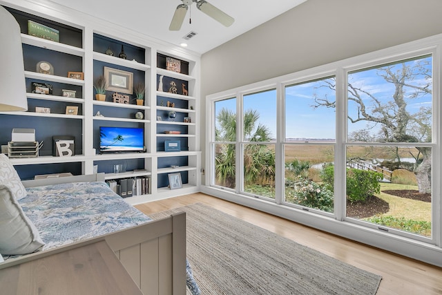 sitting room featuring visible vents, plenty of natural light, and wood finished floors