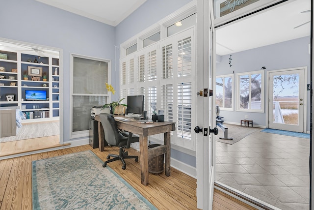 office space with wood finished floors, baseboards, and french doors