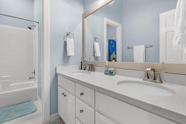 full bath featuring a sink, shower / bath combo with shower curtain, and double vanity