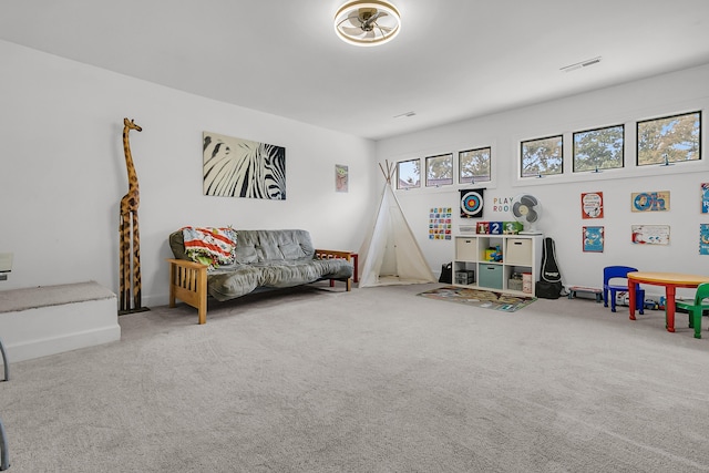 recreation room featuring plenty of natural light, visible vents, and carpet