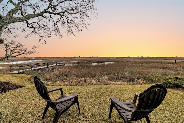 yard at dusk with a water view