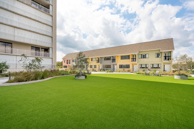 view of home's community with a yard