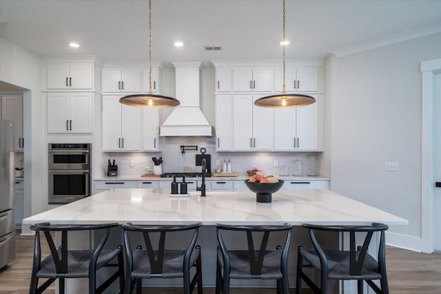 2408 Bent Oak Rd, Mount Pleasant, SC 29466 - kitchen with wood finished floors, tasteful backsplash, appliances with stainless steel finishes, ornamental molding, and recessed lighting
