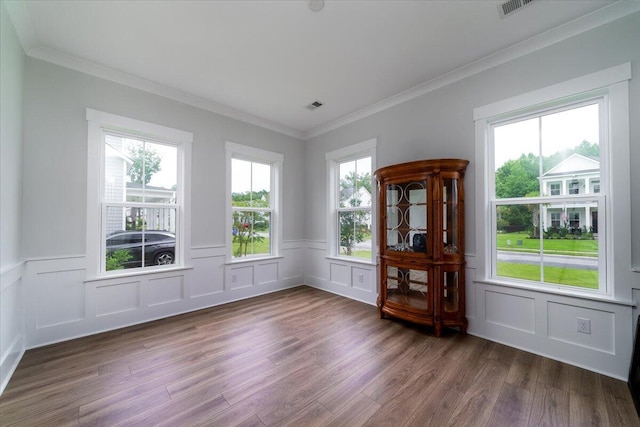 2408 Bent Oak Rd, Mount Pleasant, SC 29466 - unfurnished room with a decorative wall, wood finished floors, plenty of natural light, crown molding, and a wainscoted wall