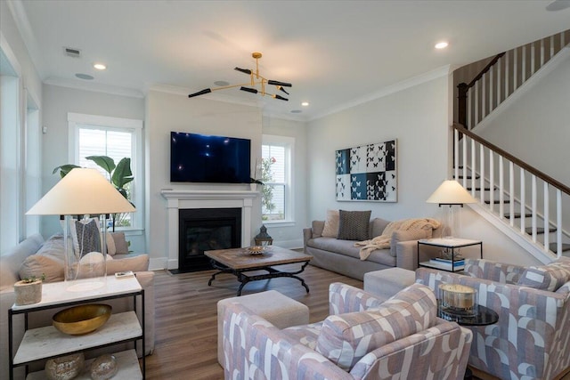 2408 Bent Oak Rd, Mount Pleasant, SC 29466 - living room with wood finished floors, stairs, crown molding, recessed lighting, and a glass covered fireplace