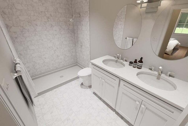 bathroom featuring vanity, toilet, and a tile shower