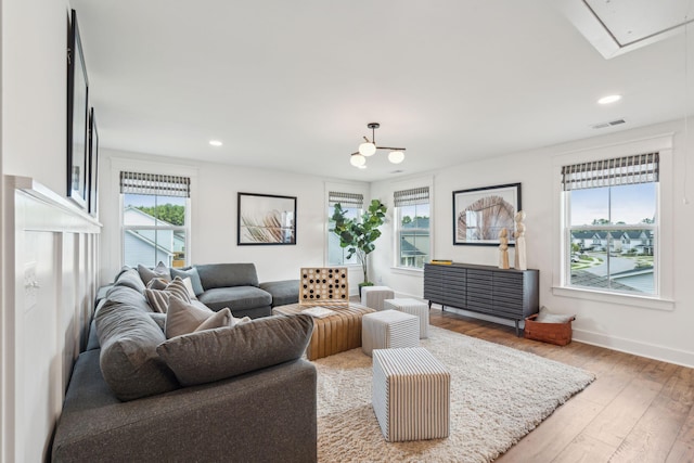 living room with hardwood / wood-style flooring and a healthy amount of sunlight