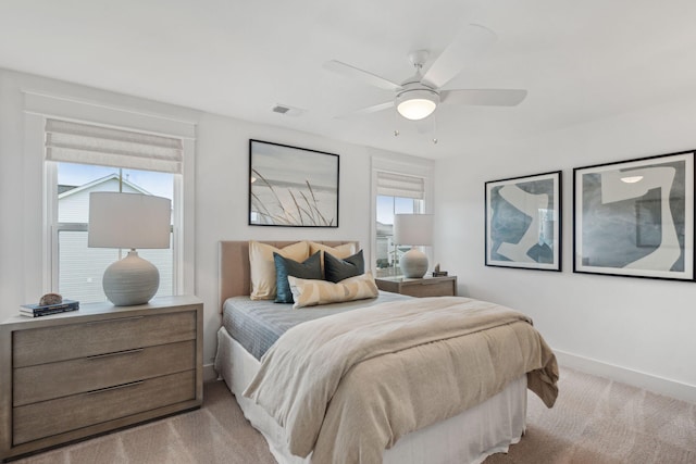 bedroom with ceiling fan and light carpet