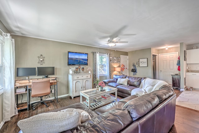 living room featuring ceiling fan and dark wood-type flooring