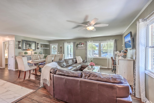 living room featuring hardwood / wood-style flooring, ceiling fan, and ornamental molding