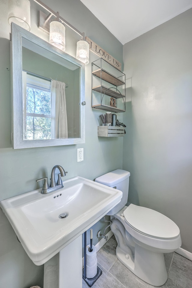 bathroom featuring tile patterned floors, sink, and toilet