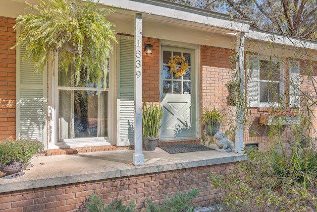 view of exterior entry featuring a porch