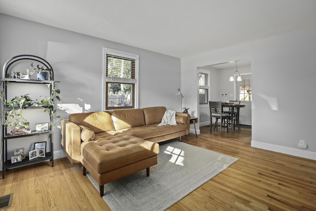 living room with plenty of natural light and light hardwood / wood-style flooring