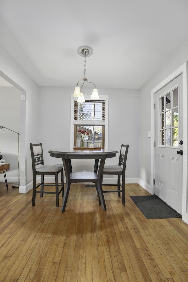 dining room featuring hardwood / wood-style flooring and a chandelier