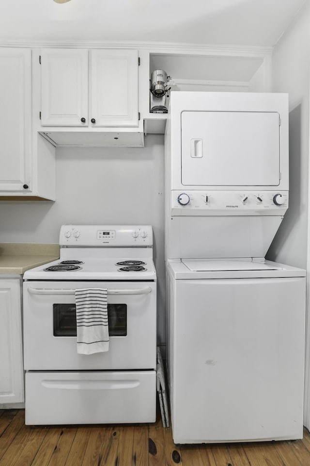 washroom with stacked washer / dryer and wood-type flooring