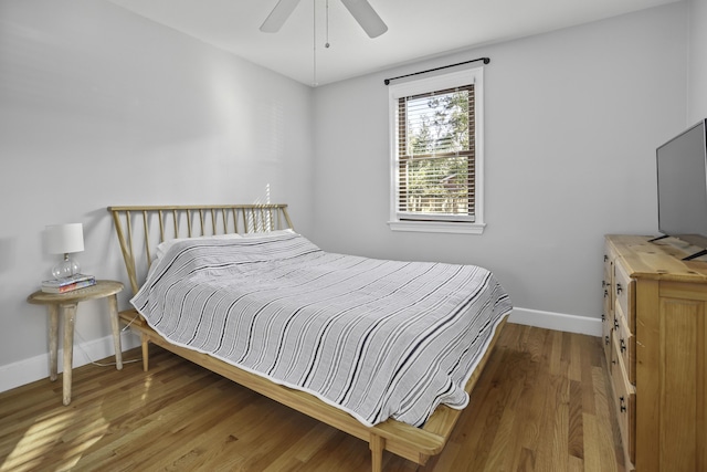 bedroom with dark hardwood / wood-style floors and ceiling fan