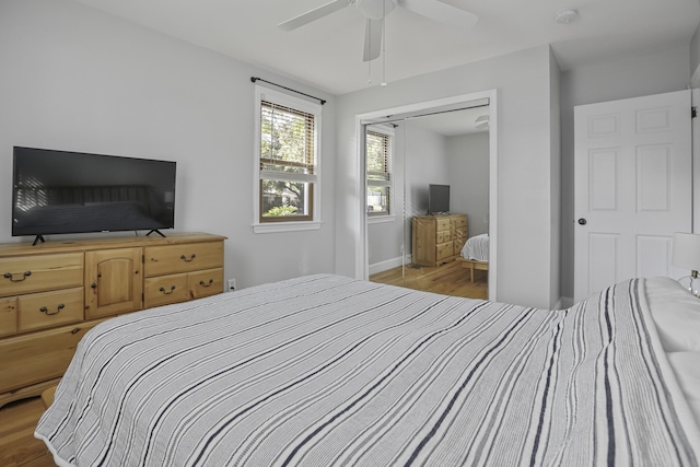 bedroom featuring ceiling fan, a closet, and light wood-type flooring