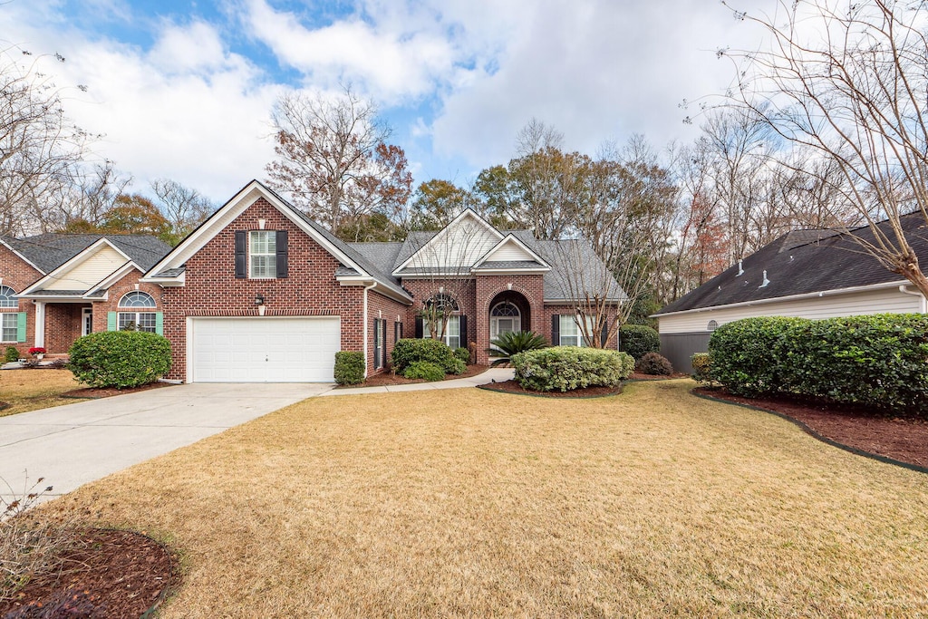 view of front of house featuring a garage and a front lawn