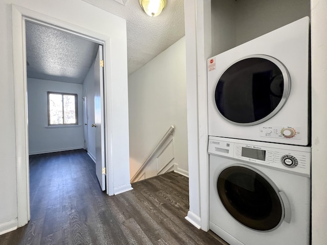 laundry room with a textured ceiling, dark hardwood / wood-style floors, and stacked washer and clothes dryer