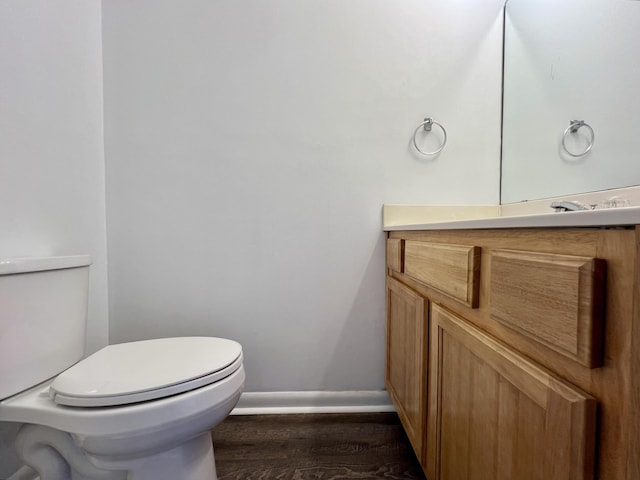 bathroom featuring hardwood / wood-style floors, vanity, and toilet