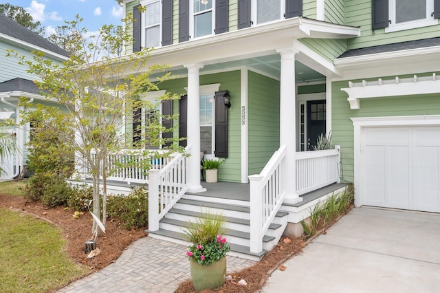 doorway to property with a porch and a garage