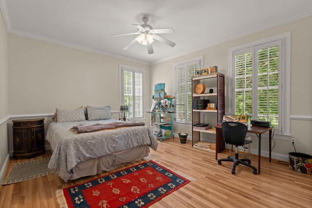 bedroom with wood finished floors, baseboards, crown molding, a desk, and ceiling fan