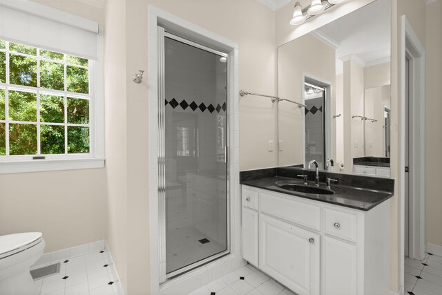 full bath featuring a shower stall, crown molding, vanity, toilet, and baseboards