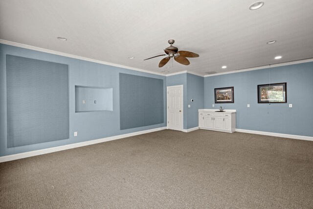 unfurnished room featuring recessed lighting, ornamental molding, ceiling fan, baseboards, and dark colored carpet