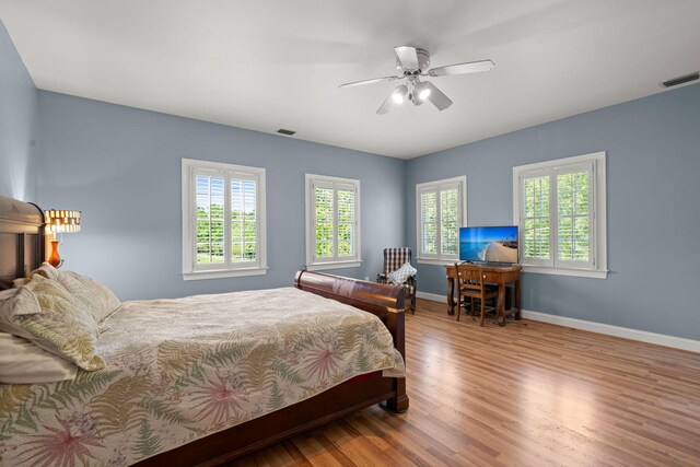 bedroom featuring wood finished floors, baseboards, and ceiling fan