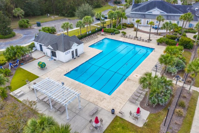 community pool featuring a pergola, fence, and a patio area