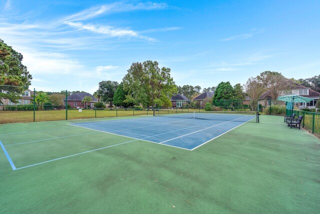 view of tennis court featuring fence and community basketball court