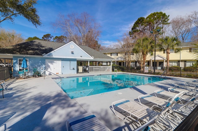 pool featuring fence and a patio