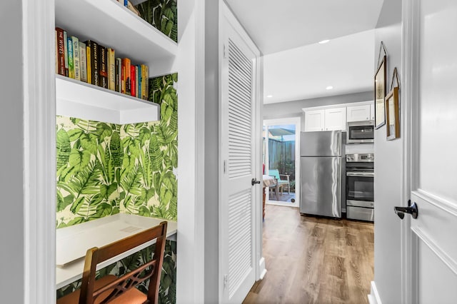 interior space featuring wood finished floors and recessed lighting