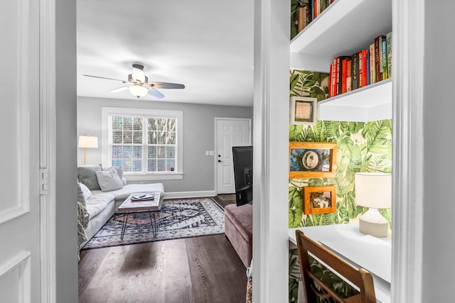 interior space with ceiling fan, wood finished floors, and baseboards