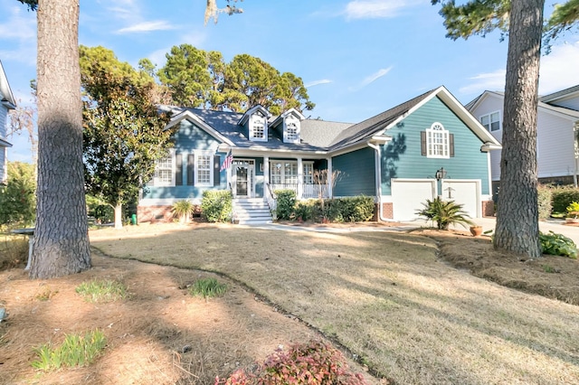 view of front of house featuring a garage, a porch, and a front lawn