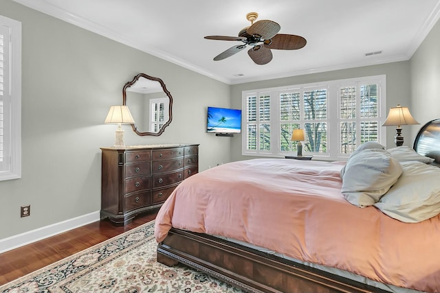 bedroom with hardwood / wood-style floors, ceiling fan, and ornamental molding