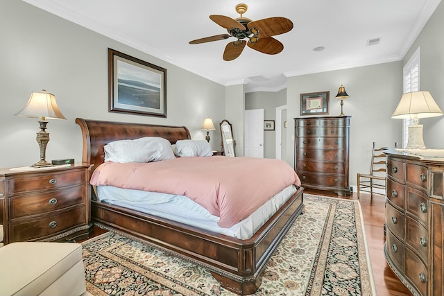 bedroom featuring ceiling fan, light hardwood / wood-style floors, and ornamental molding