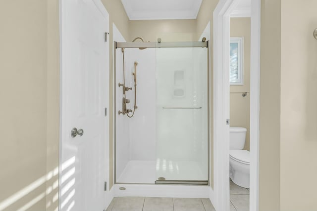 bathroom featuring walk in shower, tile patterned flooring, and toilet