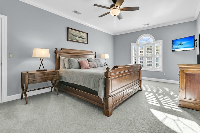 carpeted bedroom featuring ceiling fan and crown molding