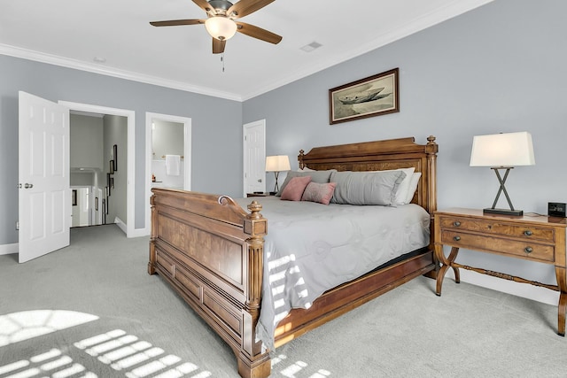 carpeted bedroom with ensuite bath, ceiling fan, and ornamental molding