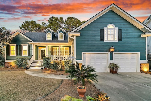 view of front of house with a garage, a porch, and a lawn